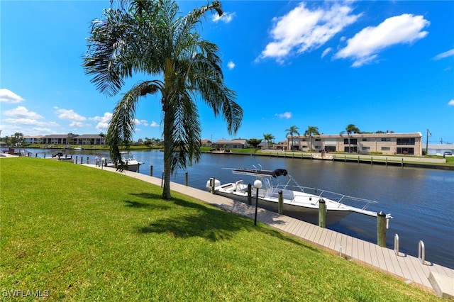 view of dock featuring a water view and a yard