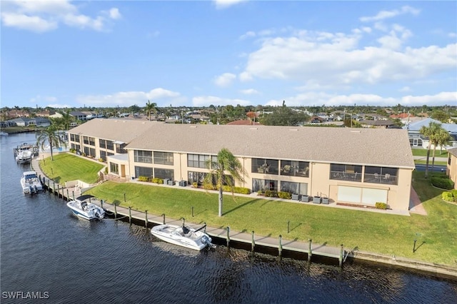 rear view of house featuring a yard and a water view