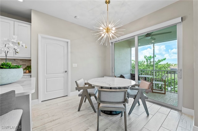 dining area featuring light hardwood / wood-style flooring and an inviting chandelier