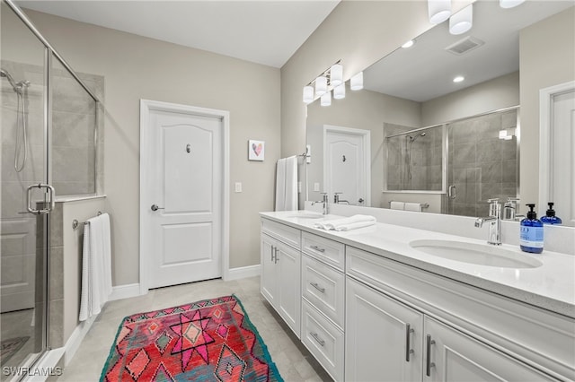 bathroom with vanity, walk in shower, and tile patterned floors