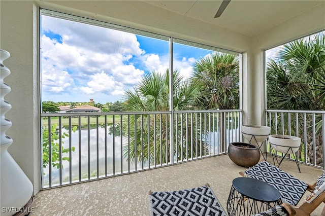 sunroom / solarium featuring a water view