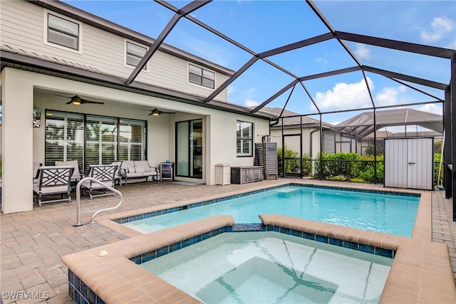 view of pool featuring ceiling fan, a lanai, an in ground hot tub, and a patio