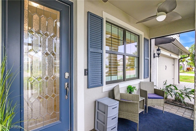 doorway to property featuring a garage and ceiling fan