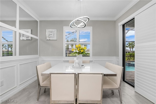 dining room featuring crown molding and a chandelier