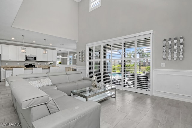 living room featuring light tile patterned floors and a high ceiling