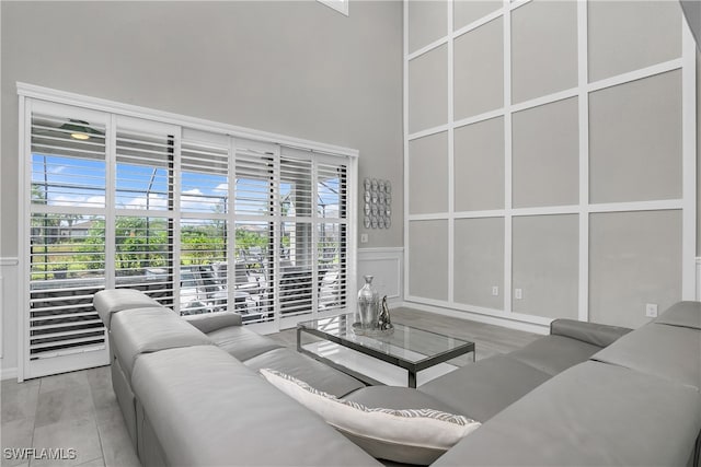 living room featuring wood-type flooring and a high ceiling