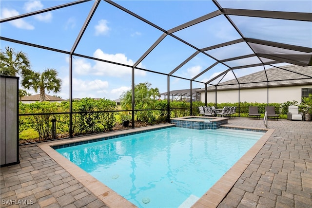 view of swimming pool with a patio area and a lanai