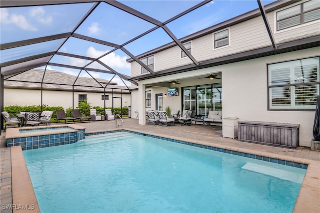 view of swimming pool featuring outdoor lounge area, a patio, glass enclosure, and ceiling fan