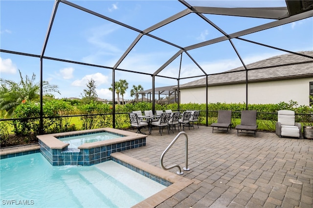 view of pool with a patio area, a lanai, and an in ground hot tub