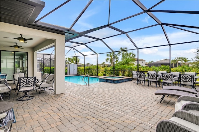 view of pool featuring glass enclosure, an in ground hot tub, and a patio