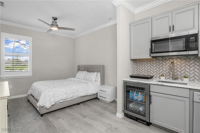 bedroom with ceiling fan, ornamental molding, sink, and beverage cooler