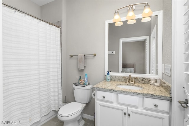 bathroom featuring tile patterned flooring, vanity, and toilet