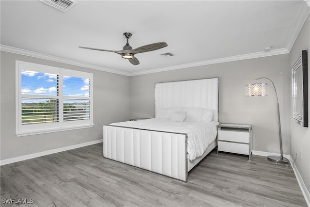 unfurnished bedroom with ceiling fan, ornamental molding, and hardwood / wood-style flooring