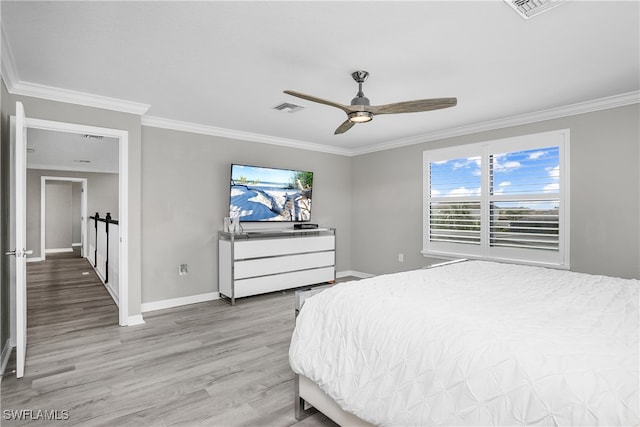 bedroom featuring ceiling fan, light hardwood / wood-style floors, and ornamental molding