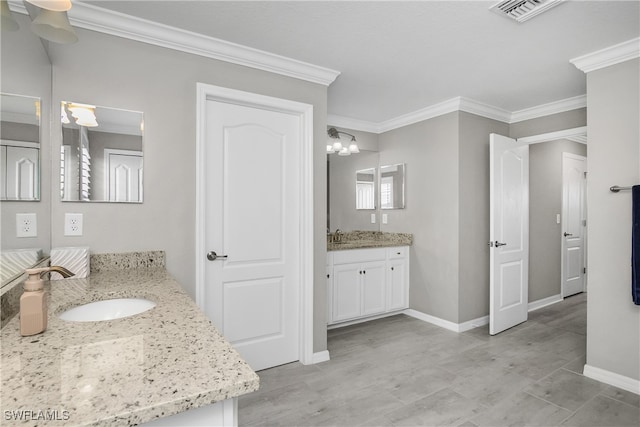 bathroom featuring vanity and ornamental molding