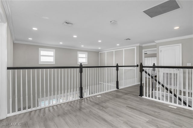 spare room with ornamental molding and hardwood / wood-style flooring