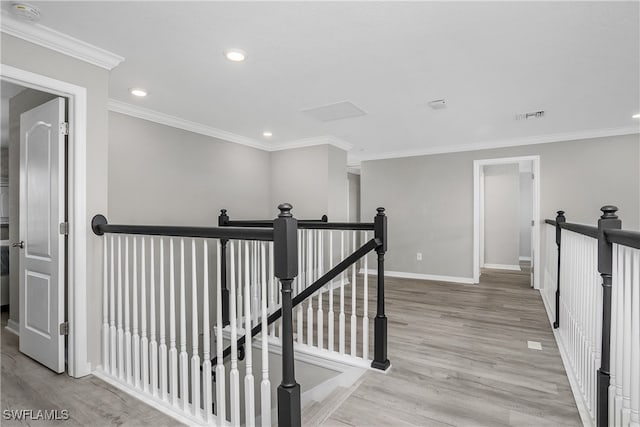 hallway featuring light hardwood / wood-style floors and ornamental molding