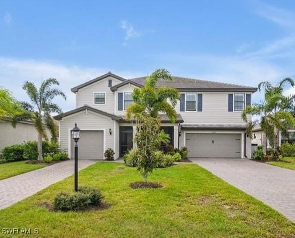 view of front of property featuring a garage and a front yard