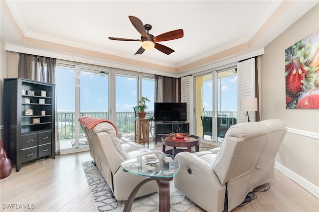 living room featuring light hardwood / wood-style flooring, ornamental molding, a wealth of natural light, and ceiling fan