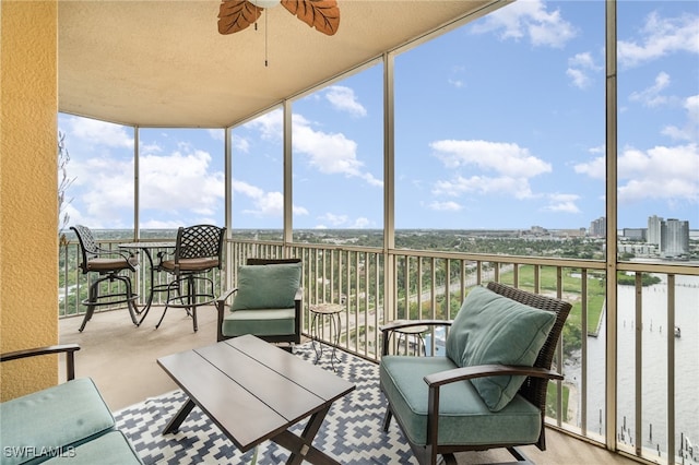 sunroom featuring ceiling fan