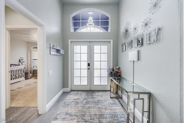 entryway with french doors and light hardwood / wood-style flooring