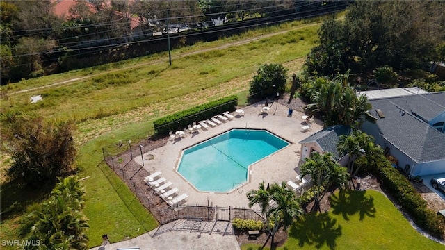 community pool featuring a patio and fence