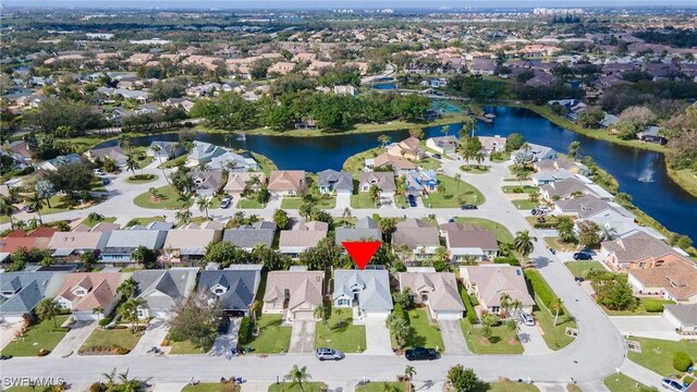 birds eye view of property with a water view and a residential view
