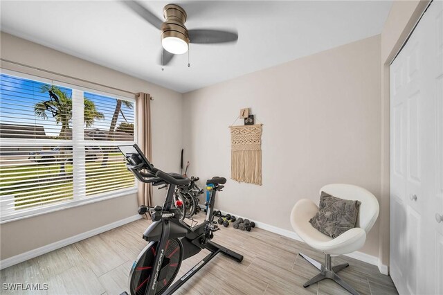 exercise room featuring ceiling fan, wood finished floors, and baseboards