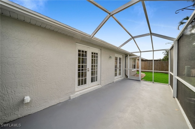 unfurnished sunroom with french doors and lofted ceiling