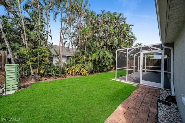 view of yard featuring a patio and a lanai