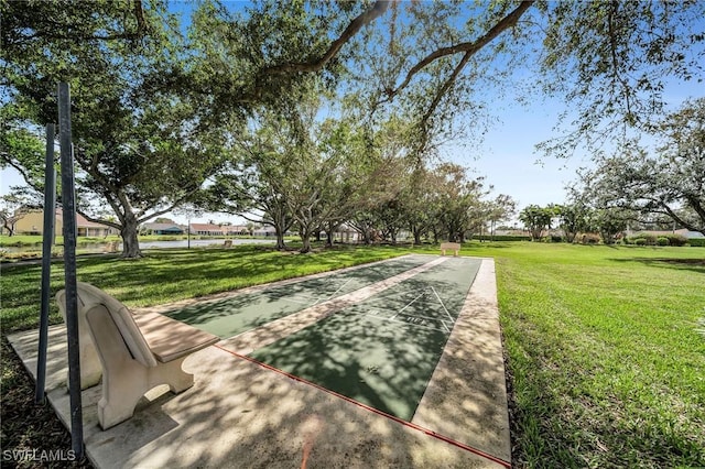 surrounding community with shuffleboard and a lawn