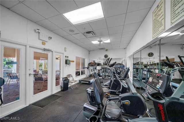 exercise room featuring a paneled ceiling, visible vents, and french doors