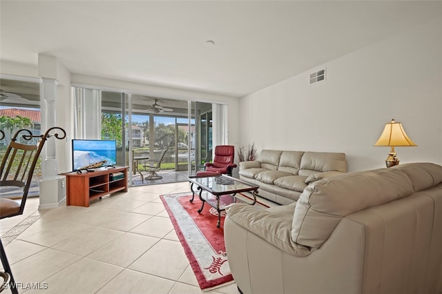 tiled living room featuring decorative columns and ceiling fan