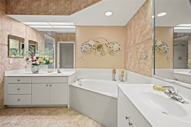 bathroom featuring vanity, tile patterned flooring, and a bathing tub