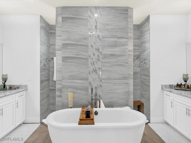 bathroom with vanity, hardwood / wood-style flooring, and independent shower and bath