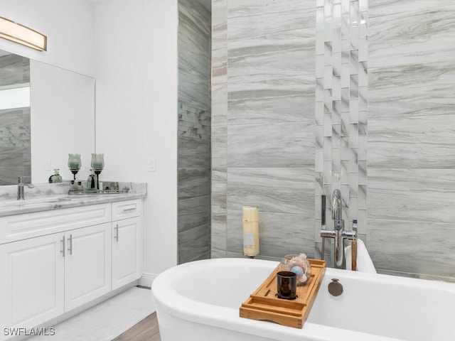 bathroom featuring vanity, a bathtub, and hardwood / wood-style flooring