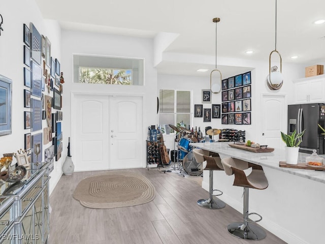 foyer entrance with light wood-type flooring