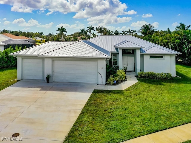 view of front of house featuring a front lawn and a garage