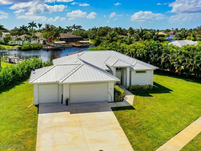 view of front of property with a water view, a front lawn, and a garage