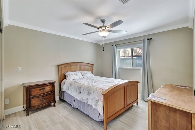 bedroom featuring light wood finished floors, baseboards, and ornamental molding