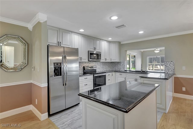 kitchen featuring white cabinets, a peninsula, visible vents, and stainless steel appliances