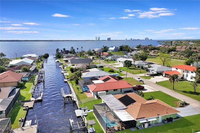 drone / aerial view with a water view and a residential view