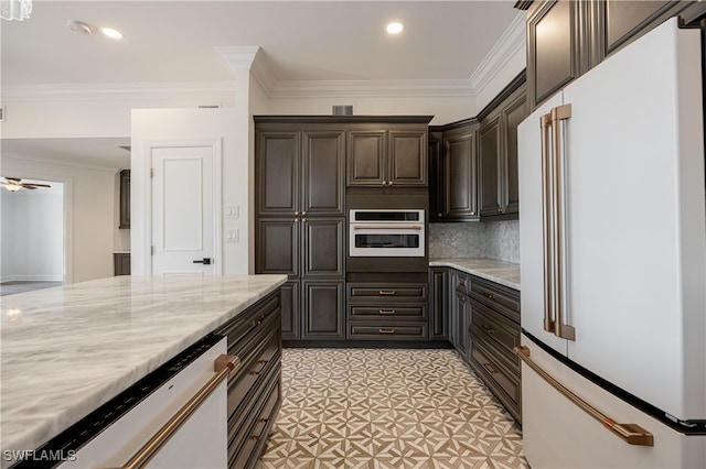 kitchen with appliances with stainless steel finishes, ornamental molding, and light stone countertops