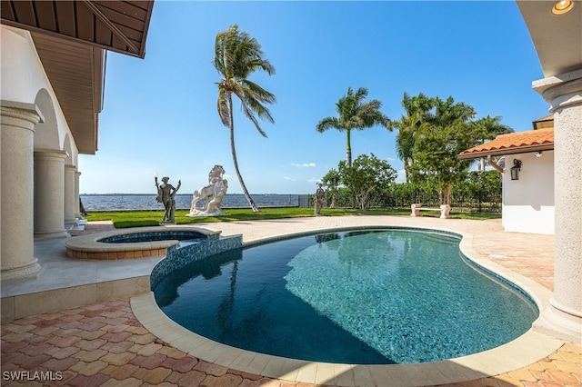 view of pool featuring a patio area, an in ground hot tub, and a water view