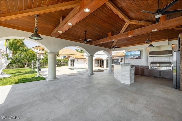 view of patio with area for grilling and ceiling fan