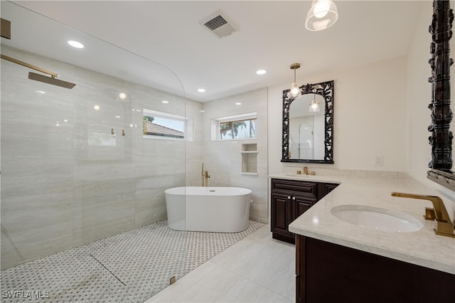 bathroom featuring vanity, shower with separate bathtub, and tile patterned flooring