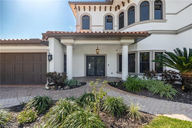 property entrance with covered porch and a garage