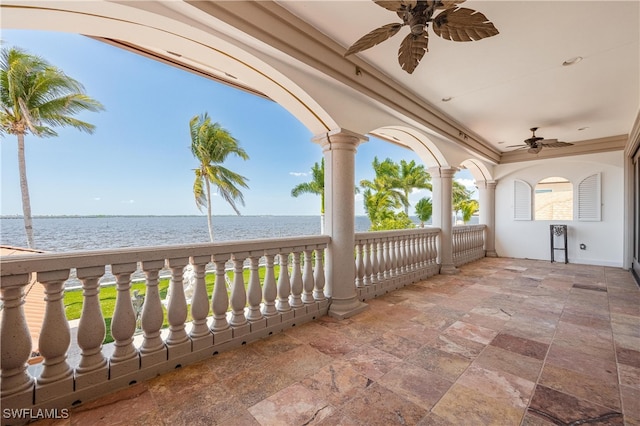 view of patio / terrace with a balcony, a water view, and ceiling fan