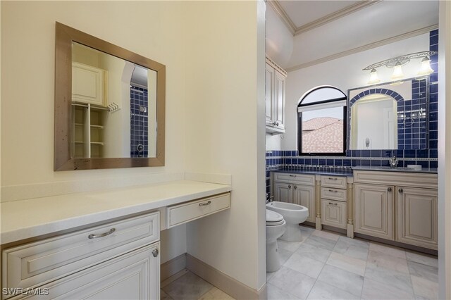 bathroom featuring decorative backsplash, toilet, vanity, ornamental molding, and a bidet