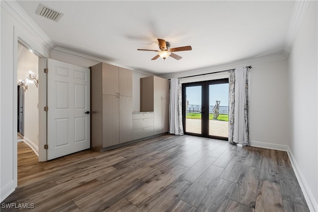 spare room featuring dark wood-type flooring, crown molding, and french doors